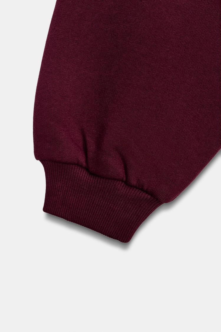 VARSITY SWEATSHIRT WITH RUFFLE TRIM